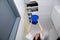 Woman Holding A Blue Bucket Under The Leak Ceiling