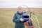 Woman holding blue helmet in hands, preparing for paragliding flight extreme sport