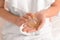 Woman holding bottle of perfume at home, closeup