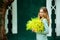 Woman holding a bouquet of mimosa, March 8 gift, celebrate live love