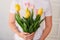 Woman holding a bouquet of spring festive tulips in her hands