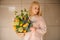 Woman holding a bouquet of tender bright yellow roses