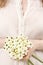 Woman holding bouquet of tiny white flowers (ornithogalum arabic