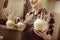 Woman holding bowls with pottery tools at at workshop