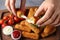 Woman holding broken cheese stick over board