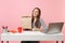 Woman holding brown clear empty blank craft paper bag, work at office with pc laptop isolated on pink background. Food
