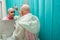 Woman holding brush and applying paints at her head while creating new look