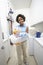 Woman Holding Bucket Of Cleaning Equipments