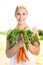 Woman holding bunch of carrots