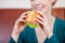 Woman Holding Burger In Coffeeshop