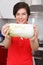 Woman holding cabbage in kitchen