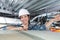 Woman holding cables overhead in roofspace