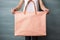 woman holding canvas bag mockup color peach fuzz