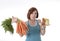 Woman holding carrots and cake healthy nutrition