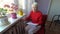 Woman holding cash in front of heating radiator. Payment for heating in winter. Selective focus.