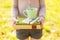 Woman holding chamomile tea and stacked books