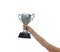 Woman holding a champion silver trophy on white background