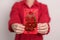 Woman holding Chinese red envelope with golden rabbit and blessing word, money gift for happy Lunar New Year holiday. Chinese