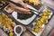 A woman holding chopsticks tries an assortment of maki rolls. At a japanese restaurant