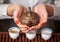 Woman holding clay teapot in front of the camera.