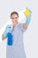 Woman Holding Cleaning Liquid And Scrubber