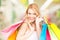 Woman holding color shopping bags in mall