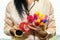 Woman holding comb and hair rollers in various colors