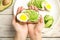 Woman holding crisp toast with avocado