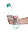 Woman holding crumpled bottle on background, closeup. Plastic recycling