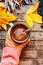 Woman holding cup of hot chocolate. Hot Chocolate in wooden tabl