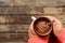 Woman holding cup of hot chocolate. Hot Chocolate in wooden tabl