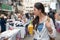 Woman holding a cup of mango juice and walking