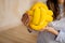 Woman holding a cute yellow knot pillow