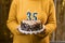 Woman holding a delicious cake with number 35 candles while celebrating birthday party. Birthday holiday party people