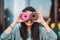 Woman is holding delicious and colored donuts with humor