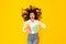 Woman Holding Detergent And Rag Advertising Cleaning Products, Yellow Background