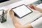 Woman holding digital tablet mockup of blank screen and computer on the table office. Take your screen to put on advertising.