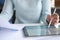 Woman holding documents in hands and working with tablet closeup