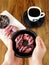 Woman is holding doughnut on a plate