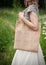 Woman holding empty linen bag. Template mock up