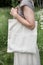 Woman holding empty linen bag. Template mock up