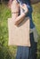 Woman holding empty linen bag. Template mock up