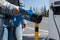 Woman holding fast charging socket CHAdeMO plug for electric vehicles at EV car charging station.