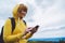 Woman holding in female hands gadget technology, tourist young girl on backgroundblu sky using mobile smartphone, smile hiker enjo