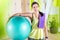 Woman holding fit ball resting after workout pilates training.