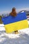 Woman holding,fluttering,waving ukrainian national blue yellow flag.war,conflict,military invasion beetwen Russia as terrorist