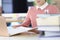 Woman holding folders with documents at table closeup