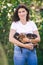 Woman holding four cute little dachshunds in domestic garden outdoors