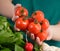 Woman holding fresh tomatoes