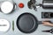 Woman holding frying pan over table with clean cookware